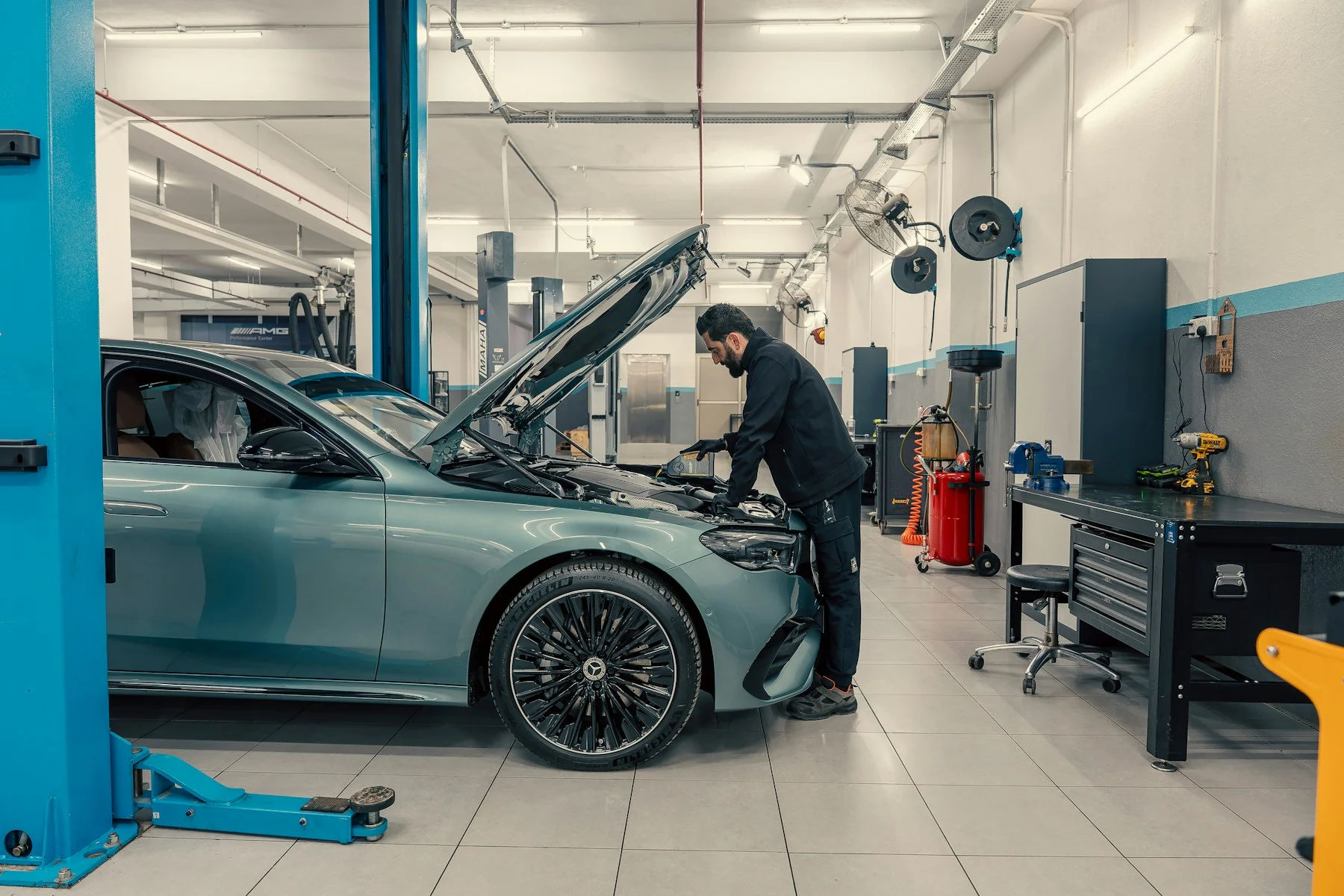 Mechanic working on a car engine in a workshop